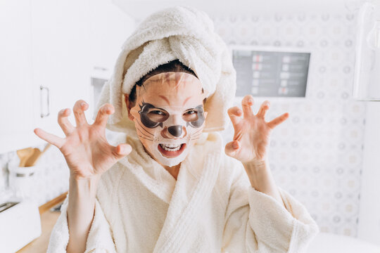 Woman fooling around in a  mask for skin in the form of a tiger