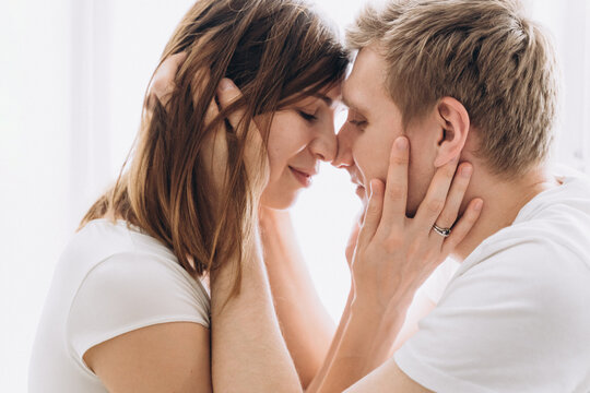 Close-up of a couple of lovers kissing on a white background