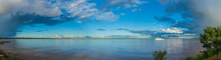 The Amazon River surrounded by rainfall clouds