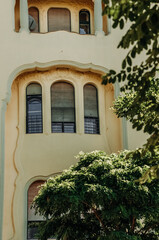 The facade of a restored house with arched windows and loggias