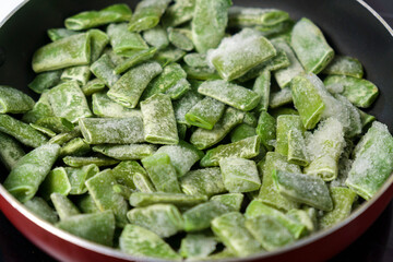 Frozen chopped asparagus beans. Fresh raw vegetable food background. Cooking concept