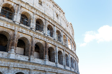 Naklejka premium The Colosseum on the reconstruction is illuminated by the summer sun
