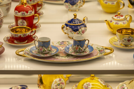 Traditional Turkish coffee mugs with a pot, decorative porcelain cups, colorful retro mug and teapot in gift shop in Istanbul, blue white cultural tea set