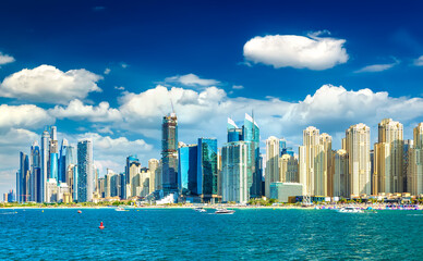 Wide panorama of Persian Gulf with famous Ferris wheel Dubai Eye and numerous skyscrapers with...