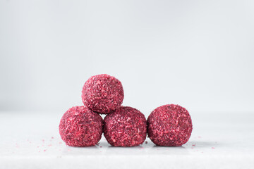Raspberry coconut and chocolate truffles, homemade chocolate bonbons on white background