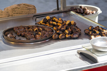 Traditional Turkish chestnut stand in Istanbul, travel in Turkey idea, street food and peddler concept, many delicious chestnuts, hot roasted nuts, Turkish cuisine