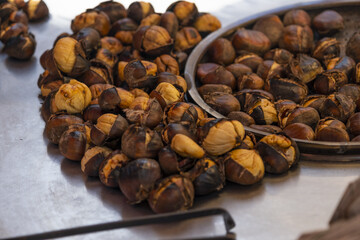 Delicious roasted chestnuts, street food and peddler concept, traditional Turkish chestnut on stand in Istanbul, travel in Turkey idea, many hot nuts, Turkish cuisine