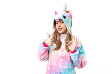Young girl with unicorn pajamas over isolated chroma key background showing ok sign and thumb up gesture