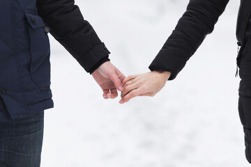 Man and woman holding hands in winter