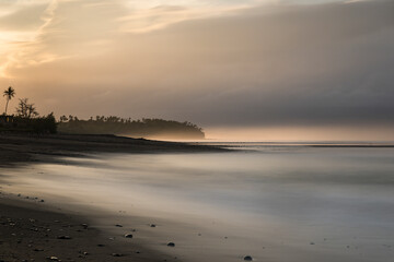 Balian black sand beach at sunrise in Bali Indonesia