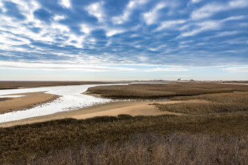 A view of marsh, river and dramatic clouds near Racepoint Lighthouse