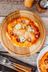 homemade pizza with sausages, cheese and vegetables