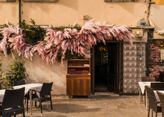 Restaurant in Venice, Italy with garland and pink feathers