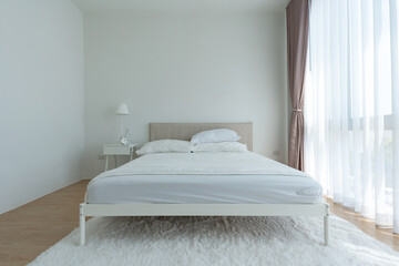 White bedroom with white curtains and white pillows