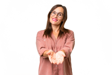 Middle-aged caucasian woman over isolated background holding copyspace imaginary on the palm to insert an ad