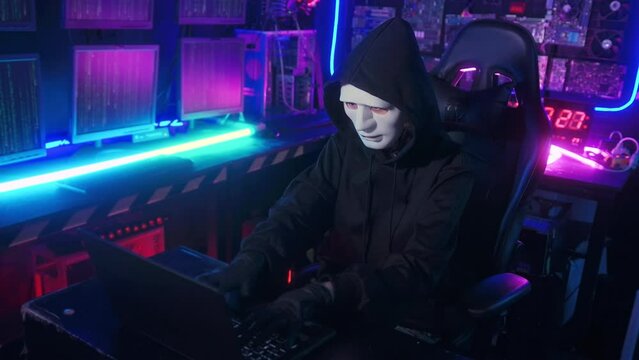 A Hacker is using laptop computer to steal data in the night