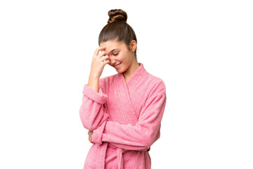 Teenager girl in a bathrobe over isolated chroma key background laughing