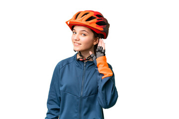 Teenager cyclist girl over isolated chroma key background listening to something by putting hand on the ear - obrazy, fototapety, plakaty