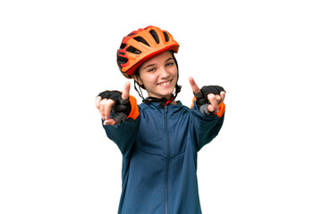 Teenager cyclist girl over isolated chroma key background points finger at you while smiling - obrazy, fototapety, plakaty