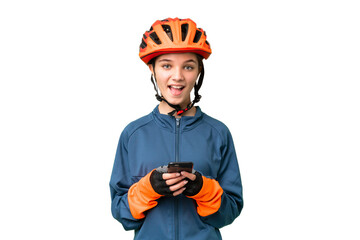 Teenager cyclist girl over isolated chroma key background surprised and sending a message - obrazy, fototapety, plakaty