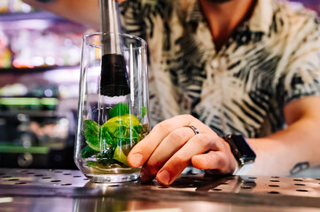 bartender preparing mojito cocktail drink in bar