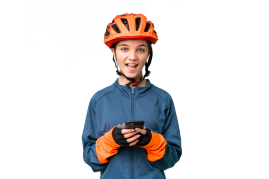 Teenager cyclist girl over isolated chroma key background surprised and sending a message