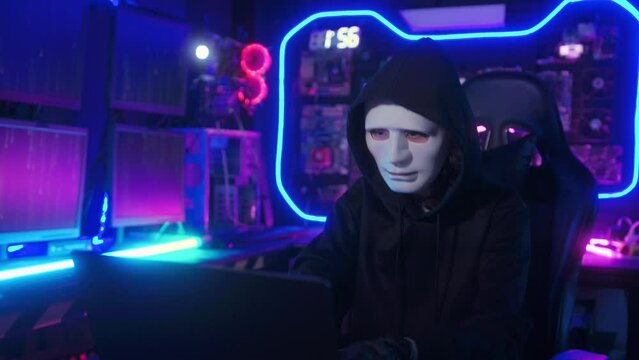 A Hacker is using laptop computer to steal data in the night