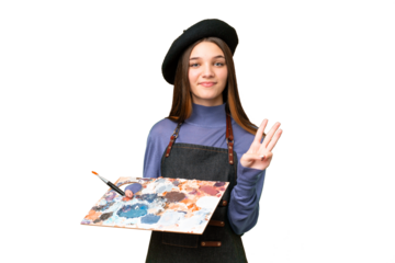 Young artist man holding a palette over isolated chroma key background happy and counting three with fingers