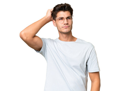 Young caucasian handsome man over isolated background having doubts while scratching head