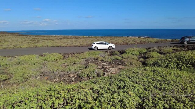 Europe, Spain, Lanzarote,  Canary Islands 2023 - Timanfaya nationl parck is a volcanic biosfera reserve tourist attraction - queue of cars in line traffic car of tourists visiting the amazing nature 