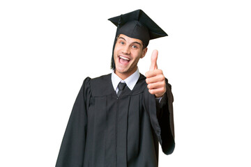 Young university graduate caucasian man over isolated background with thumbs up because something good has happened