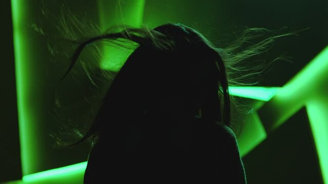 Close up portrait of pretty brunette female model . Beautiful attractive face of young woman . Hair flowing or blowing in wind . Face Changes Depending on the Lighting . Shadow and light movement . 