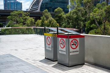 no smoking sign on the side of bins located outdoor of building in city