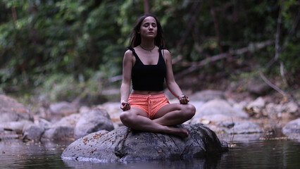 Woman relaxing meditating pose at beautiful Thai landscape in lotus position.Recreation on Koh Samui