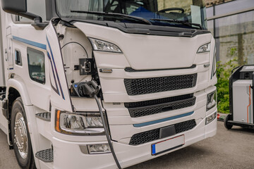 Electric truck batteries are charged from the charging station. Concept