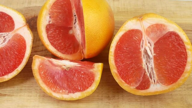 Many fresh fruits lie on the table. Beautiful grapefruit for healthy eating. Citruses lie beautifully on a white table.