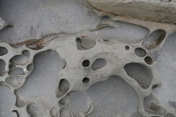 texture of porous stones on the beach, nature, natural phenomena, brown-gray stones