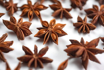 A lot of star anise on a white background close-up