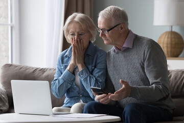 Shocked upset elderly couple getting bad news, finding fraud, money stealing, loss, overspending,...