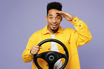 Young smiling man of African American ethnicity wear yellow shirt t-shirt hold steering wheel drive car hold hand at forehead isolated on plain pastel light purple background People lifestyle concept