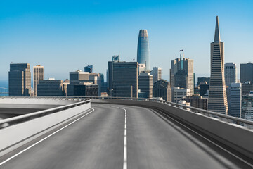 Fototapeta na wymiar Empty urban asphalt road exterior with city buildings background. New modern highway concrete construction. Concept way to success. Transportation logistic industry fast delivery. San Francisco. USA.