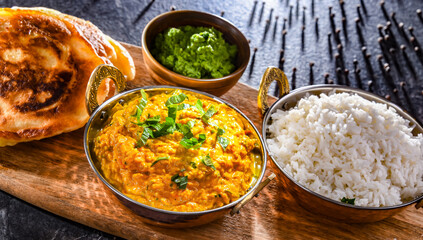 Curry chicken with rice served in original indian karahi pots