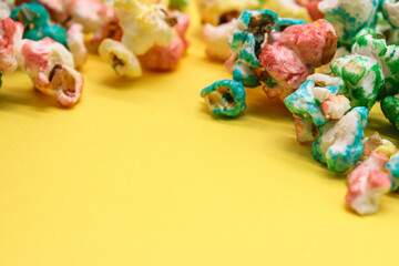 colored popcorn isolated on yellow background