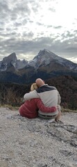 Fototapeta premium person sitting on a mountain top