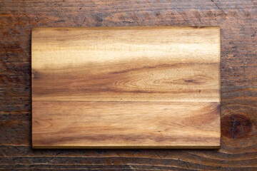 Cutting board on wood kitchen table. Food recipe concept at wood background texture with copy space.