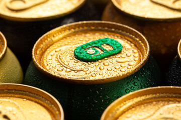 Metal cans of beer, close up. Drops of water on a cold can of drink. Alcoholic beverage.