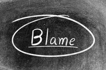 White chalk hand writing in word blame and circle shape on blackboard background
