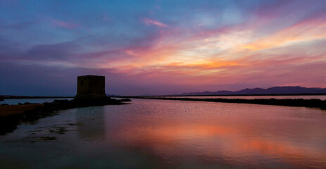 Tamarit Tower in Santa Pola. Old coastal watchtower located on a sea-salt plain. Nice sunset in Santa Pola seafaring city in the valencian community, Alicante, Spain