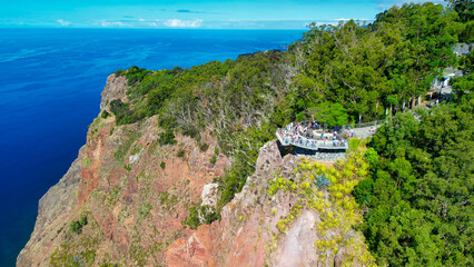 Tourists enjoy the viewpoint at Cabo Girao, along the Madeira coastline, Portugal. Aerial view from...