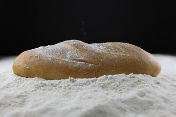 Baking. Baked bread. Bread on flour, a lot of white flour. Loaf with a crispy crust. Fresh breakfast, for sandwiches. Hearty food.